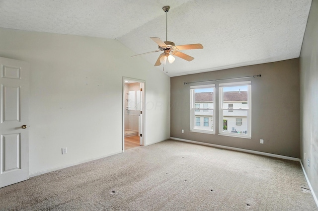 unfurnished bedroom with carpet flooring, baseboards, lofted ceiling, a textured ceiling, and ensuite bathroom