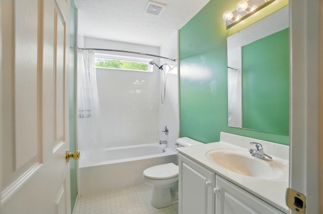 bathroom with a textured ceiling, toilet, vanity, and shower / bath combination with curtain
