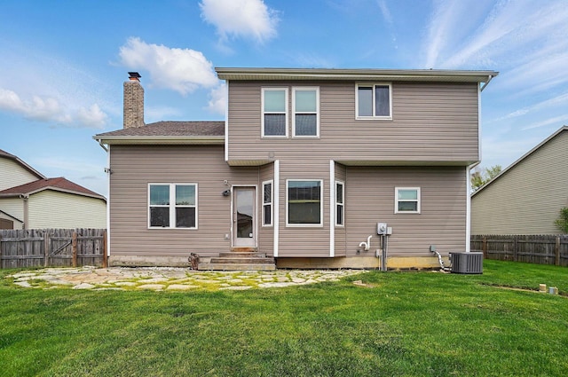 back of property featuring entry steps, a chimney, and central air condition unit