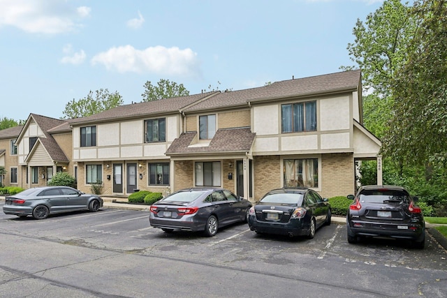 5692 Great Hall Ct, Columbus, OH 43231 - multi unit property with uncovered parking, brick siding, stucco siding, and roof with shingles