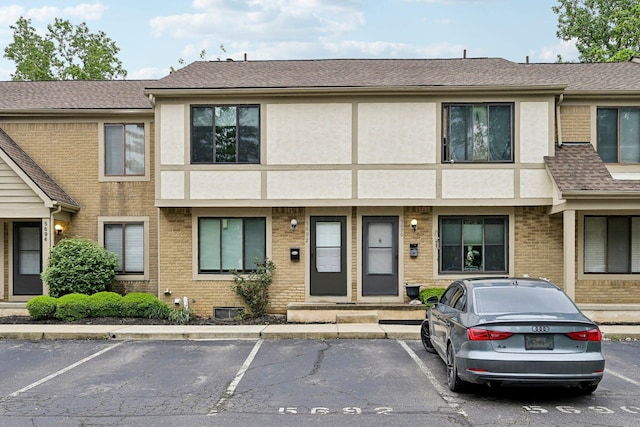 5692 Great Hall Ct, Columbus, OH 43231 - multi unit property with uncovered parking, stucco siding, and roof with shingles