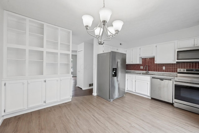 5692 Great Hall Ct, Columbus, OH 43231 - kitchen with stainless steel appliances, a chandelier, a sink, light countertops, and white cabinetry