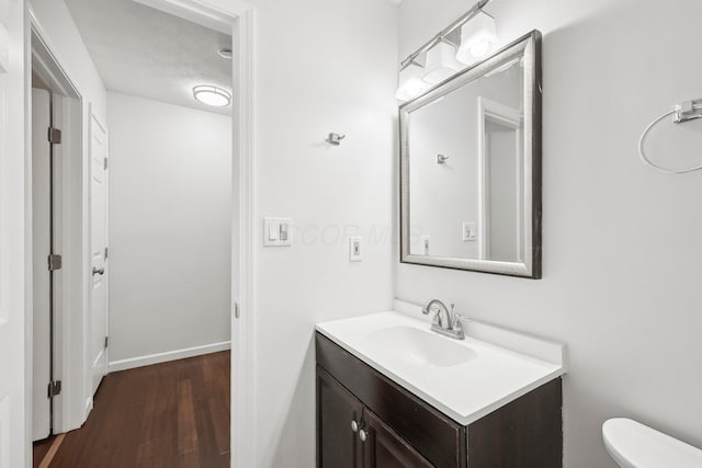 5692 Great Hall Ct, Columbus, OH 43231 - half bathroom featuring vanity, wood finished floors, and toilet
