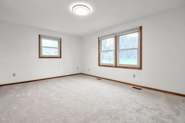 spare room featuring visible vents and carpet