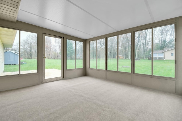 unfurnished sunroom with carpet and a wealth of natural light