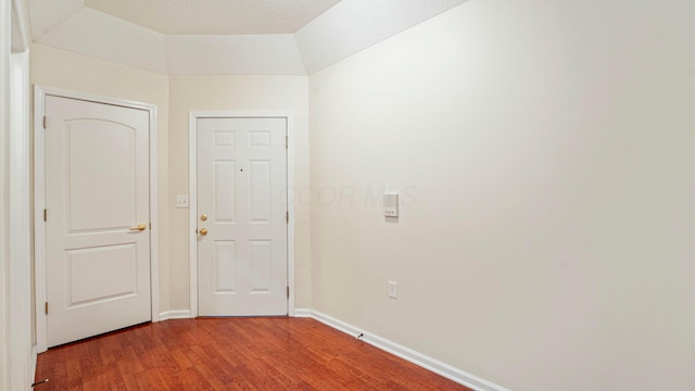 unfurnished room with wood finished floors and baseboards