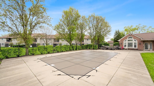 view of pool featuring a patio area, a residential view, a fenced in pool, french doors, and fence