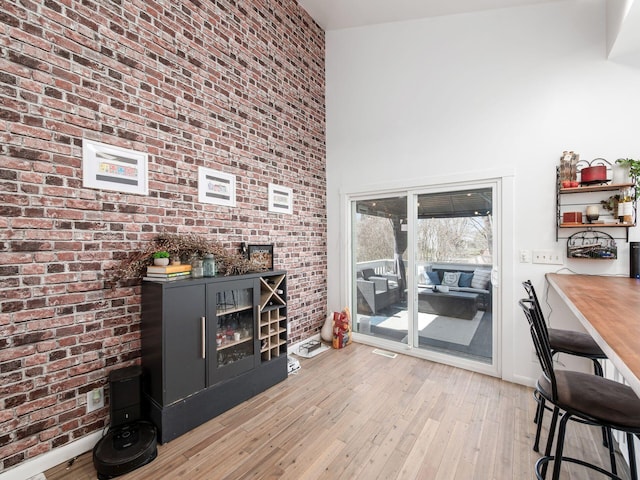 2600 Seneca Dr, London, OH 43140 - interior space with hardwood / wood-style floors, a high ceiling, and brick wall