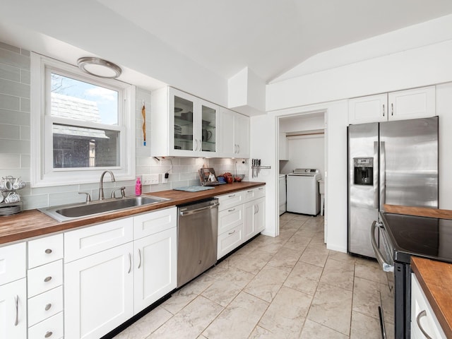 2600 Seneca Dr, London, OH 43140 - kitchen featuring wood counters, stainless steel appliances, tasteful backsplash, a sink, and vaulted ceiling
