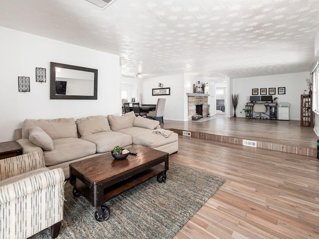 2600 Seneca Dr, London, OH 43140 - living room featuring visible vents, wood finished floors, and a textured ceiling