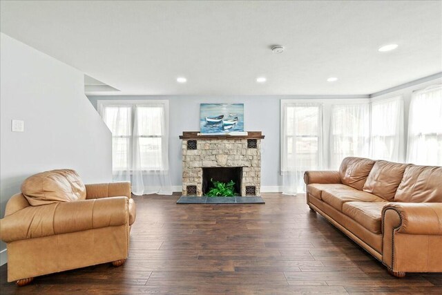 8119 State Route 366, Russells Point, OH 43348 - living area featuring baseboards, dark wood-style flooring, recessed lighting, and a stone fireplace