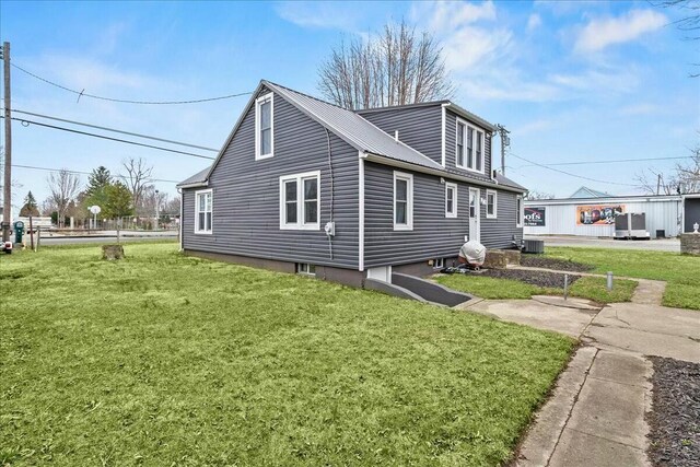8119 State Route 366, Russells Point, OH 43348 - view of side of home with central AC unit, metal roof, and a yard