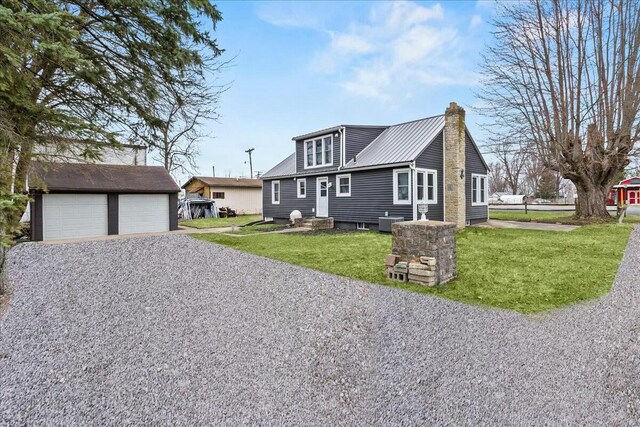8119 State Route 366, Russells Point, OH 43348 - view of front of property featuring a front yard, a chimney, an outdoor structure, metal roof, and entry steps