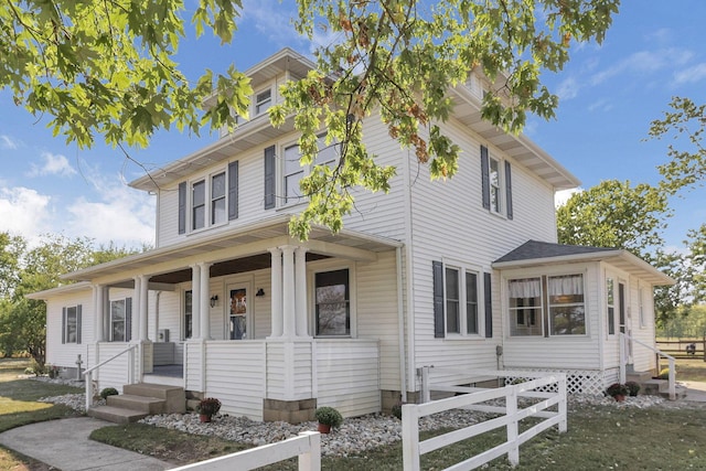 american foursquare style home with covered porch