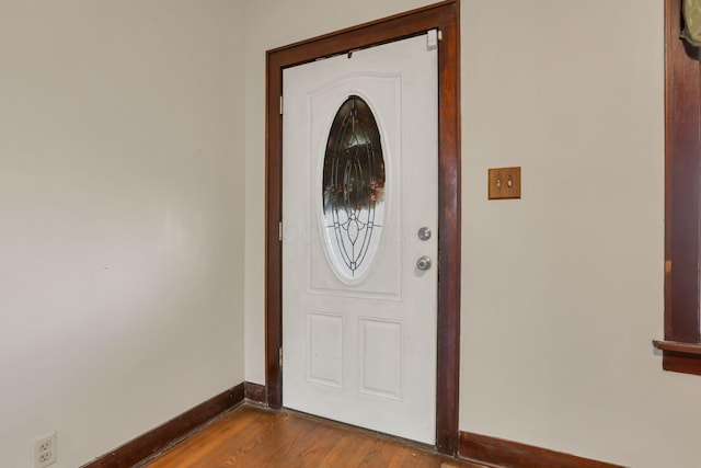entrance foyer with dark wood-style floors and baseboards