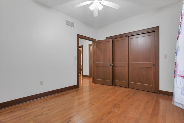 unfurnished bedroom with baseboards, visible vents, light wood-style floors, and ceiling fan