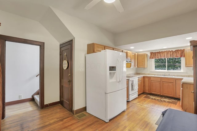 kitchen featuring light countertops, white appliances, ceiling fan, a sink, and light wood-style floors