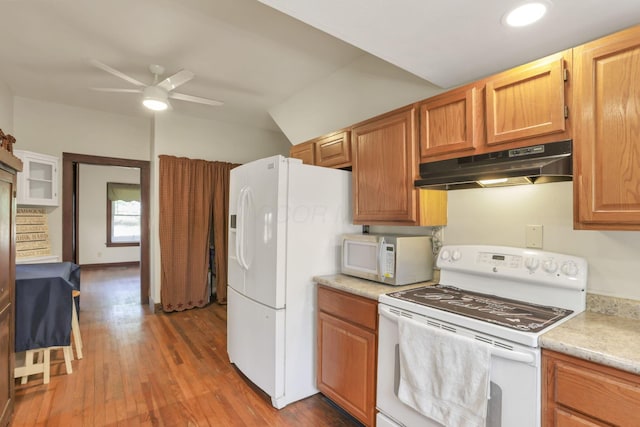 kitchen with light countertops, white appliances, under cabinet range hood, ceiling fan, and wood finished floors