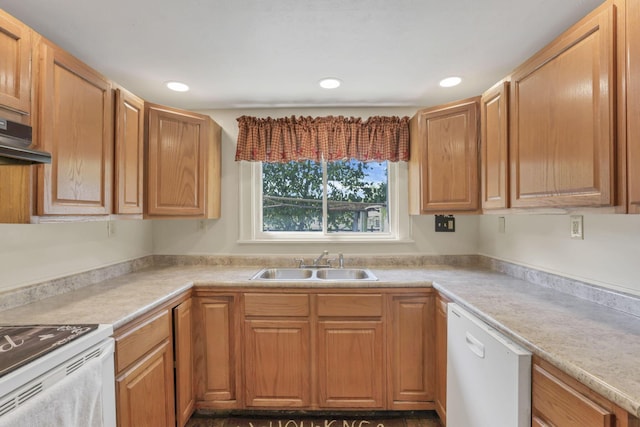 kitchen with light countertops, a sink, recessed lighting, and white appliances