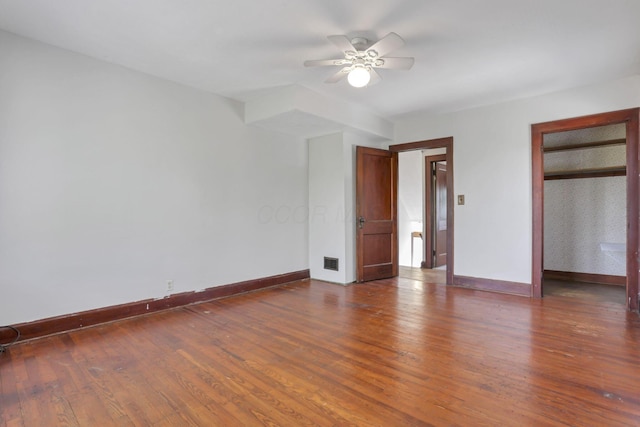 unfurnished bedroom with dark wood-style flooring, baseboards, and visible vents