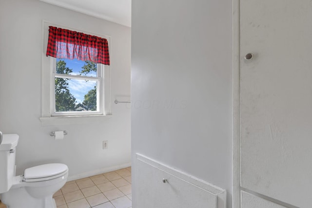 bathroom featuring tile patterned floors, toilet, and baseboards
