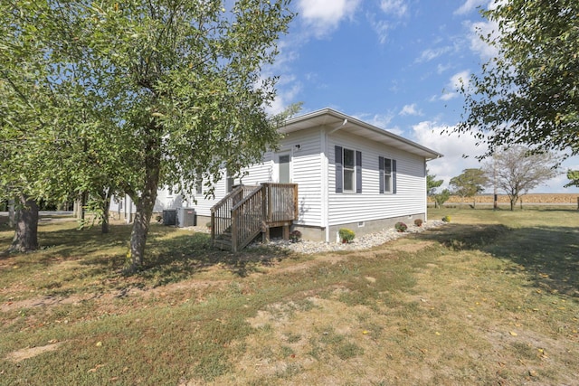 view of side of property with a lawn