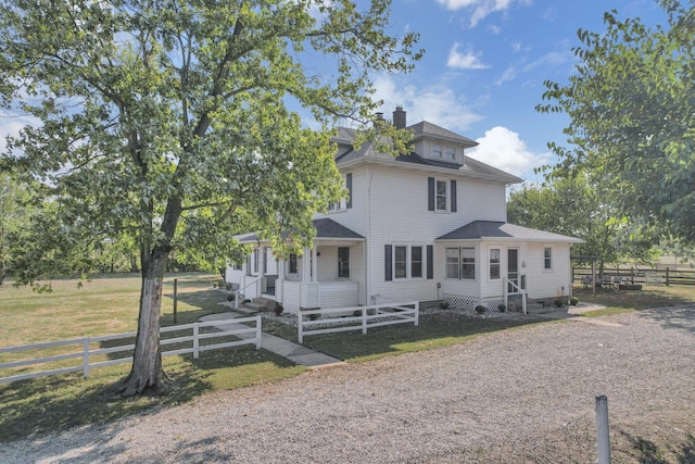 american foursquare style home featuring a chimney, roof with shingles, fence, and entry steps