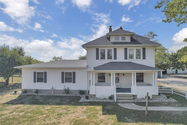 traditional style home with fence, covered porch, a chimney, a front yard, and a shingled roof
