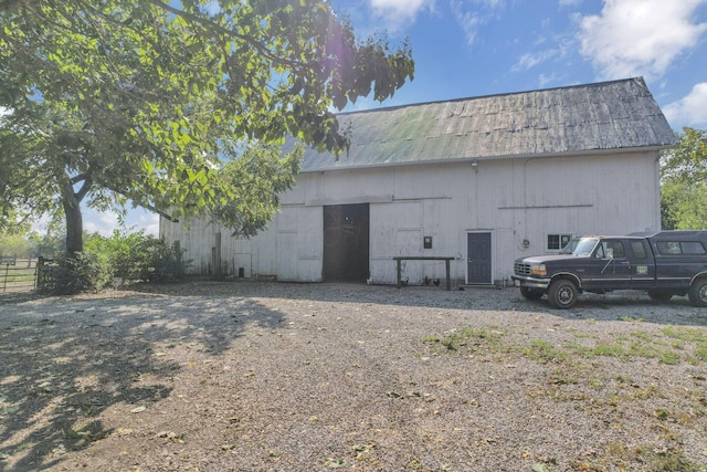 view of pole building with fence