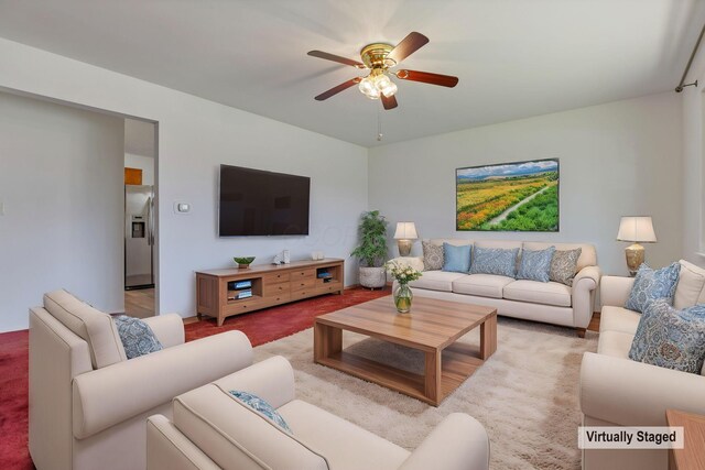 living room with light carpet and a ceiling fan