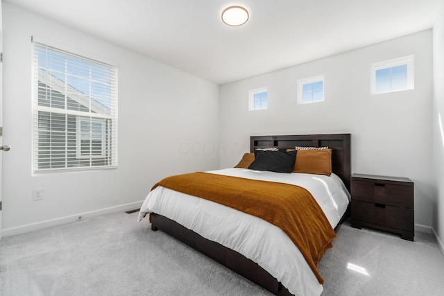 bedroom with carpet flooring and baseboards
