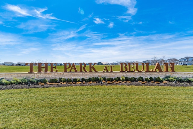 community / neighborhood sign with a lawn