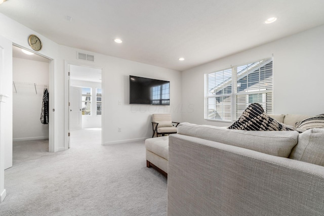living room featuring light carpet, baseboards, visible vents, and recessed lighting