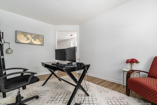 office space with baseboards and wood finished floors