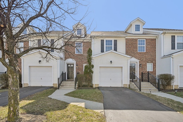 1143 Green Knoll Dr, Westerville, OH 43081 - townhome / multi-family property with driveway, a garage, and brick siding