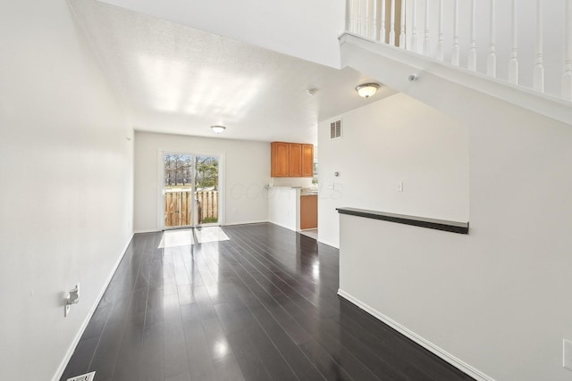 1143 Green Knoll Dr, Westerville, OH 43081 - unfurnished living room featuring dark wood-style floors, baseboards, and visible vents