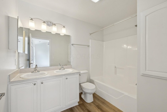 1143 Green Knoll Dr, Westerville, OH 43081 - full bathroom featuring double vanity, a sink, toilet, and wood finished floors