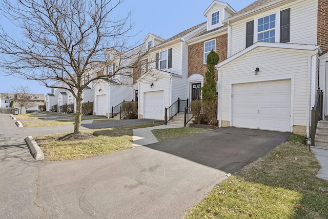 1143 Green Knoll Dr, Westerville, OH 43081 - townhome / multi-family property featuring a residential view, a garage, and aphalt driveway