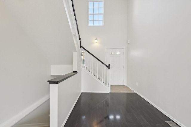 1143 Green Knoll Dr, Westerville, OH 43081 - entryway featuring stairway, baseboards, a high ceiling, visible vents, and wood finished floors