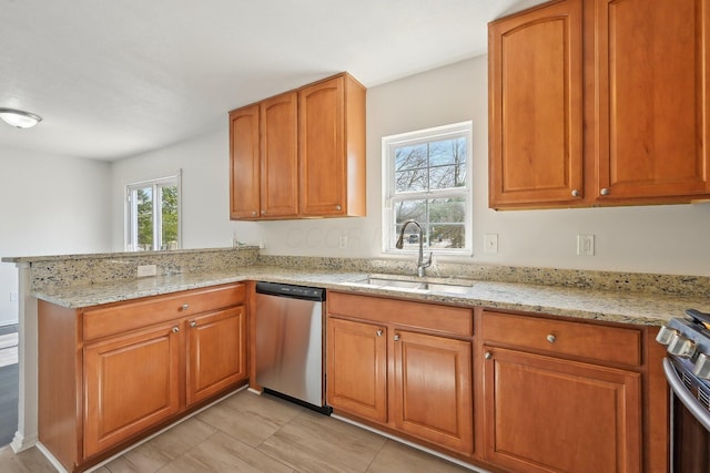 1143 Green Knoll Dr, Westerville, OH 43081 - kitchen featuring light stone countertops, a peninsula, a sink, and stainless steel appliances