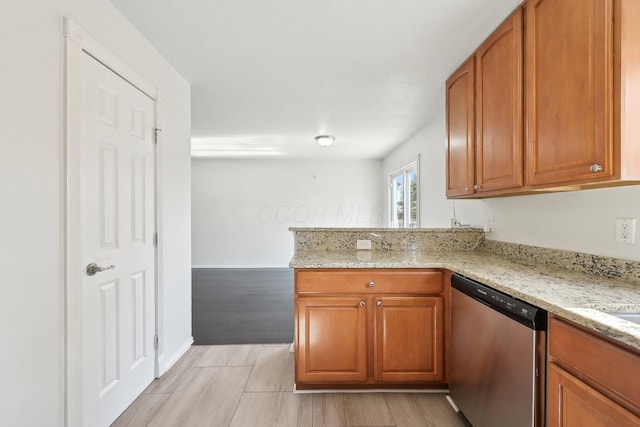 1143 Green Knoll Dr, Westerville, OH 43081 - kitchen featuring a peninsula, light stone counters, brown cabinetry, and stainless steel dishwasher