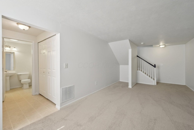 1143 Green Knoll Dr, Westerville, OH 43081 - bonus room featuring carpet, stairway, a textured ceiling, and visible vents