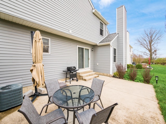 view of patio with entry steps, a grill, and central AC unit