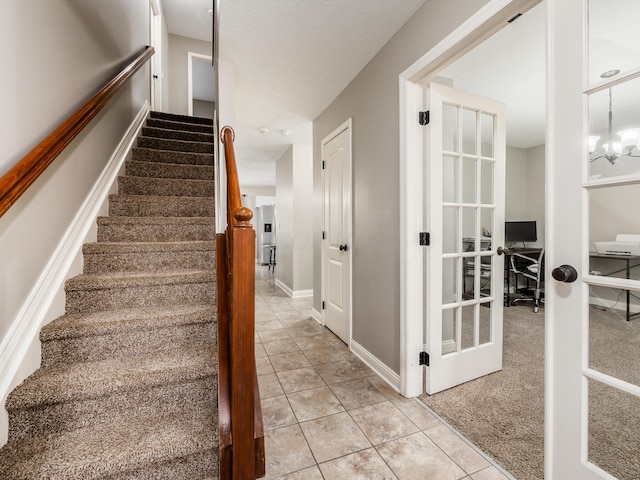 stairs with baseboards and tile patterned flooring