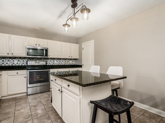 kitchen featuring white cabinets, a breakfast bar, and stainless steel appliances
