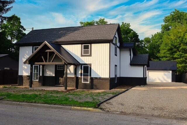 16786 Main St, Williamsport, OH 43164 - view of front of property featuring a shingled roof, gravel driveway, and an outdoor structure