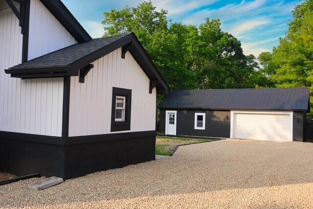 16786 Main St, Williamsport, OH 43164 - view of side of home with an outbuilding, driveway, and roof with shingles