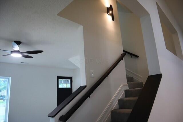 16786 Main St, Williamsport, OH 43164 - staircase with healthy amount of natural light and a ceiling fan