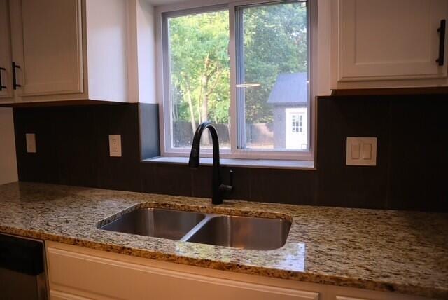 16786 Main St, Williamsport, OH 43164 - kitchen with white cabinetry, light stone counters, tasteful backsplash, and dishwasher