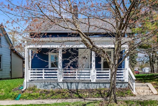 view of front facade featuring a porch and a shingled roof